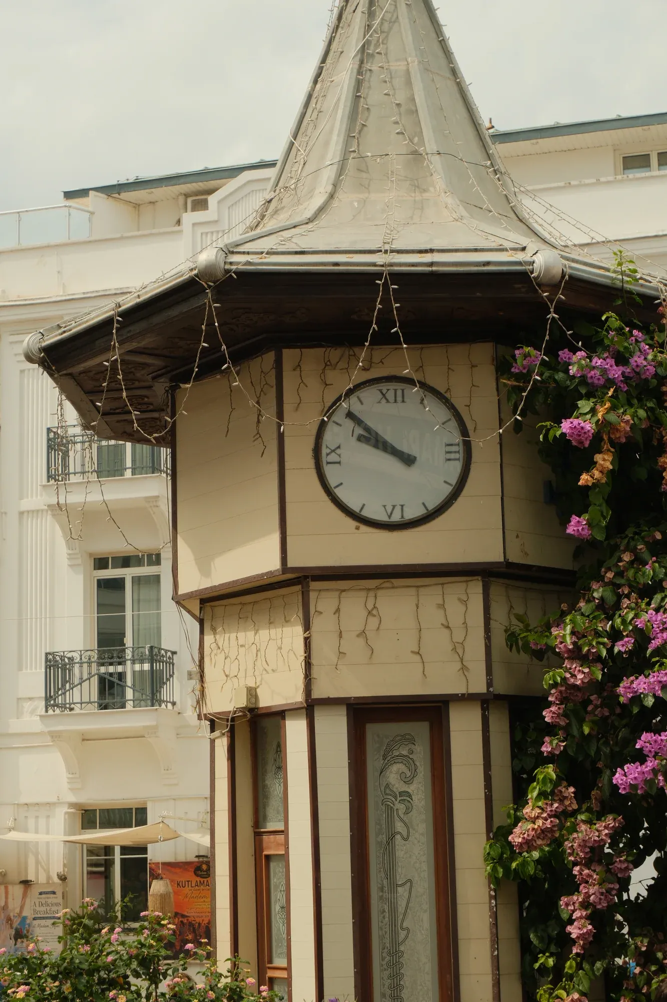 A clock tower framed by flowering vines on Büyükada